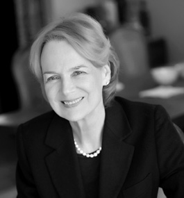 Black-and-white head shot of a smiling woman